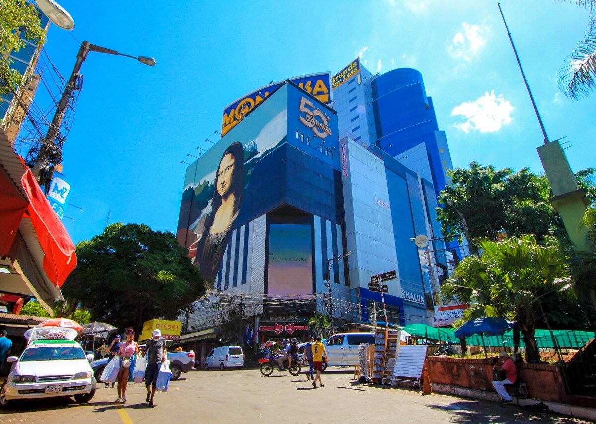Rua comercial com guarda-chuvas coloridos em Ciudad del Este